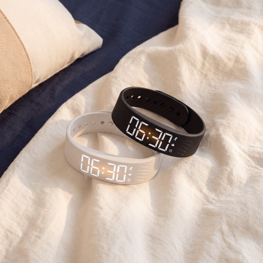 Two Sotto bands, black and white, on a linen bedsheet